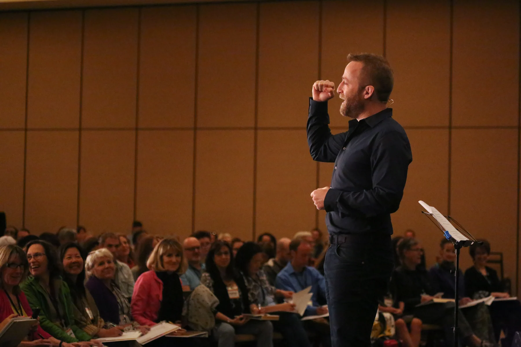Justin Livingston speaking to a full room