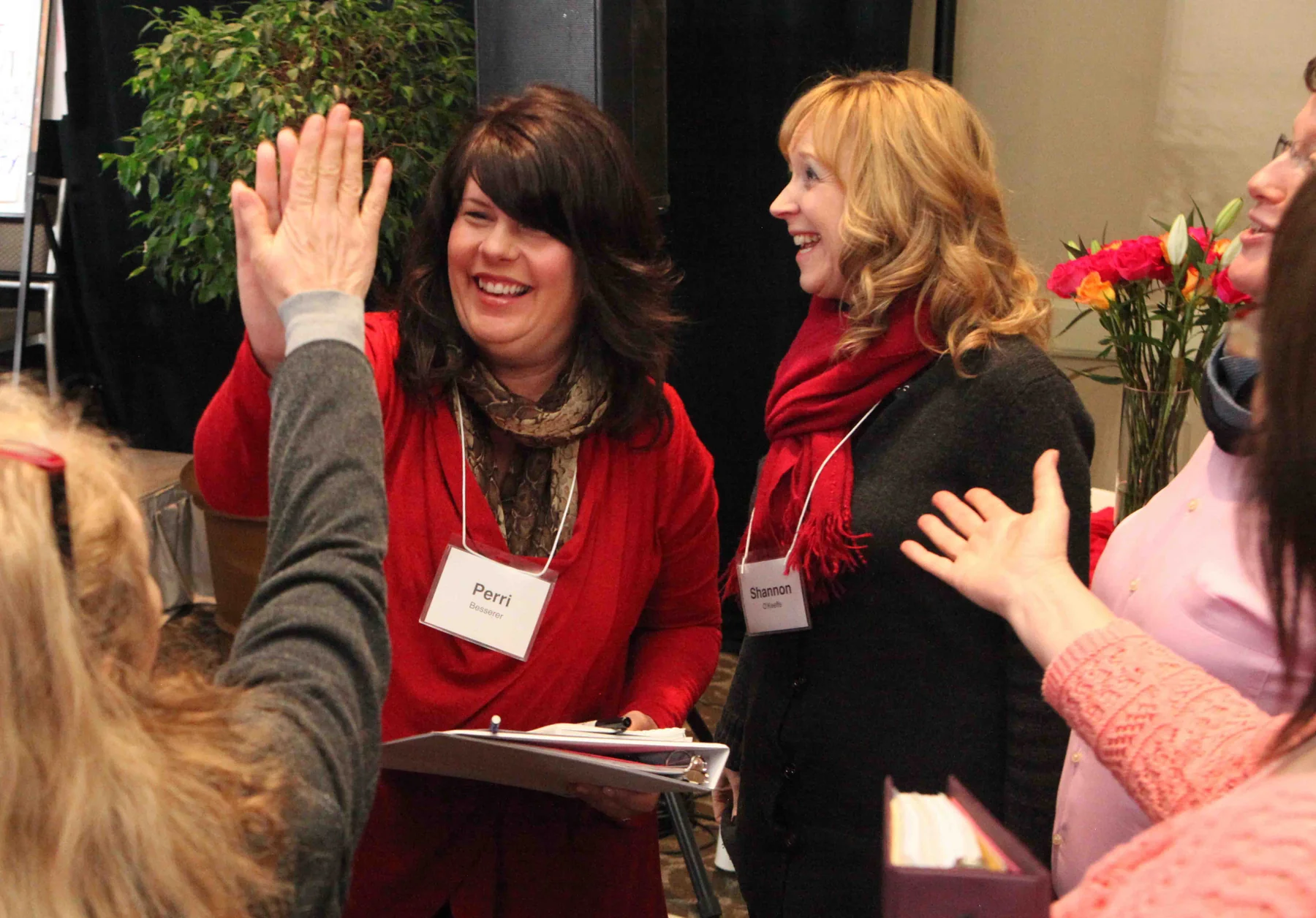 Two workshop participants smiling and high-fiving